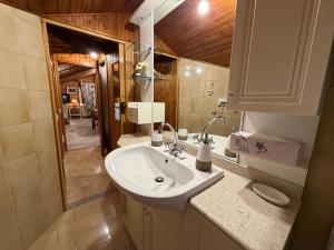 a bathroom with a sink and a mirror at Graziosa mansarda rustica - CIR VDA 0038 in Aosta +8 photos