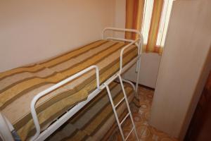 a bunk bed in a room next to a window at Residence Rondinelle in Lignano Sabbiadoro