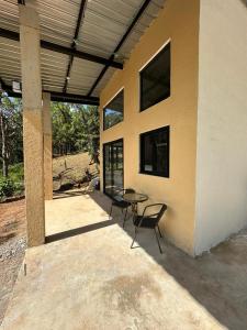 a patio with a table and chairs next to a building at Blue Dream in Los Altos de Cerro Azul