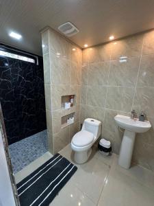 a bathroom with a toilet and a sink and a shower at Blue Dream in Los Altos de Cerro Azul