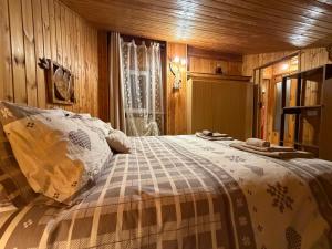 a bedroom with a bed in a wooden room at Graziosa mansarda rustica - CIR VDA 0038 in Aosta