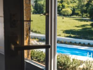 an open window with a view of a pool at Hotel Zubieta in Lekeitio
