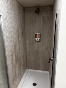a bathroom with a shower with a camera on the wall at The Riverwood Retreat in St. Charles +12 photos