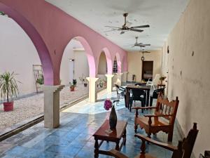 a living room with arches and tables and chairs at casa bajlum in Valladolid