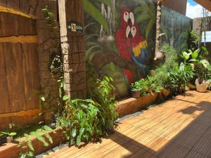 a mural on the side of a building with plants at Hotel Matrin in Barretos