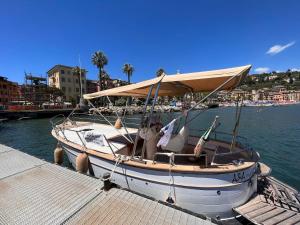 a boat is docked at a dock in the water at Hostello Genovese in Genoa