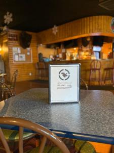 a sign sitting on a table in a restaurant at The Moosehead in Glenwood