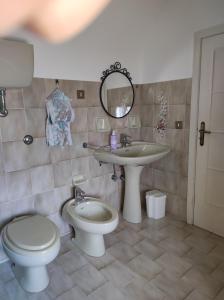 a bathroom with a toilet and a sink at Dimora San Pietro in Ferrandina +19 photos