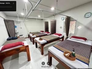 a room with a bunch of beds in it at Mook Phoopha Guest House in Ko Mook