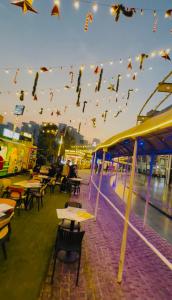 a bunch of kites flying in the sky over tables at The dream studio in Noida