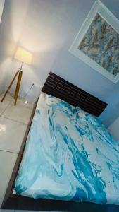 a bedroom with a bed with a painting on the wall at The dream studio in Noida