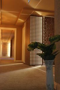a vase with a plant in the middle of a room at Bonnie City Hotel in Antalya