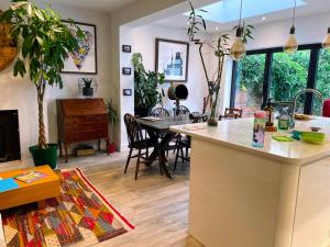 a kitchen and living room with a table and chairs at En-Suite Private Room Brocton Village in Bednall +4 photos