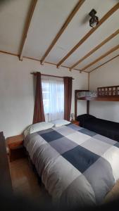 a bedroom with a large bed in a room at Casa Torres in Curacautín