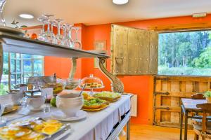 a kitchen with orange walls and a table with food on it at Hotel Zubieta in Lekeitio