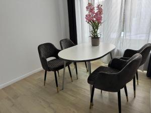 a white table and chairs with a potted plant on it at Dream Holiday Haus in Uetersen