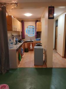 a kitchen with a sink and a refrigerator at Marima Safari in Sekenani