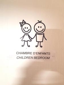 a cartoon of a boy and a girl holding hands at Beaune Residence appartement in Beaune