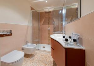 a bathroom with a toilet and a sink and a shower at Canonica Apartment - Eclettica Hospitality in Venice
