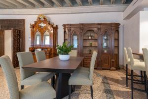 a dining room with a wooden table and chairs at Canonica Apartment - Eclettica Hospitality in Venice