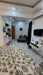 a living room with a large bed and a couch at The Blue Heaven in Noida