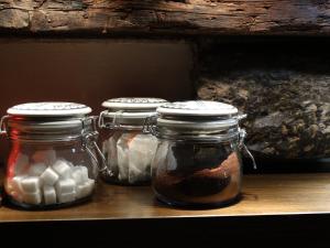 a row of glass jars sitting on a shelf at Huyze Peerdenbrugghe in Bruges +22 photos