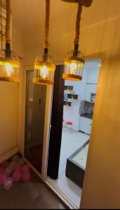 a mirror in a room with lights hanging over it at The Blue Heaven in Noida