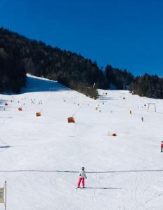 a group of people skiing down a snow covered slope at Mountain View House - Panoramic! in Gozd Martuljek
