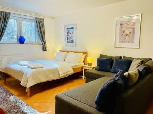a living room with a couch and a bed at Mountain View House - Panoramic! in Gozd Martuljek