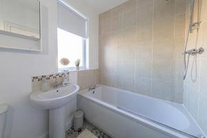 a bathroom with a sink and a toilet and a bath tub at The Relaxation Station in Bishop Auckland +17 photos