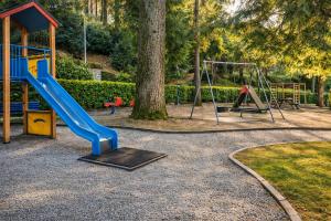 a playground with a slide and a swing at Il Gerlo in Lezzeno