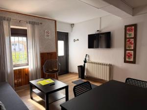 a living room with a couch and a table at Casa Escalones in Villalba