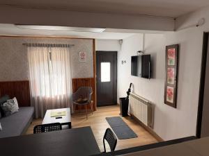 a living room with a couch and a table at Casa Escalones in Villalba