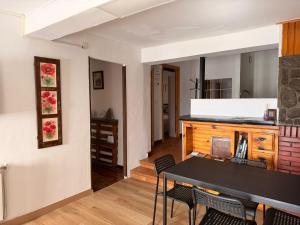 a dining room with a table and chairs at Casa Escalones in Villalba