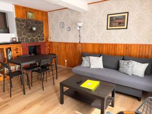 a living room with a couch and a table at Casa Escalones in Villalba