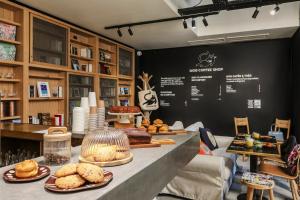 a bakery with breads and pastries on a counter at MOB HOTEL Paris Les Puces in Saint-Ouen +41 photos