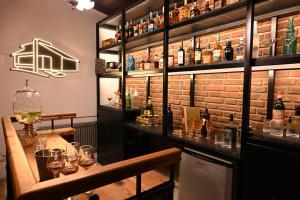 a bar with a wooden table and bottles of wine at Castelvi casa boutique in Saladillo