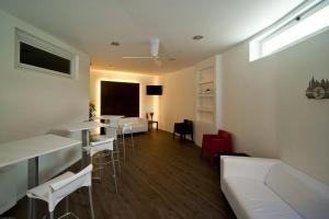 a living room with a couch and a table and chairs at Hotel Dei in Cascia