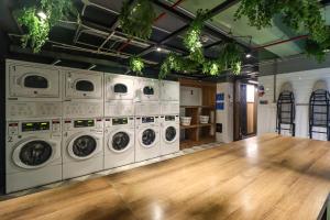 a laundry room with a bunch of washing machines at Happa Hub Hotel in Bogotá