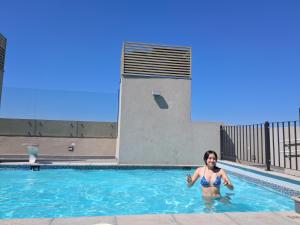 a woman is standing in a swimming pool at Plaza ñuñoa in Santiago