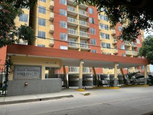 a apartment building with a sign in front of it at KD Prime Suite Al Norte de la Ciudad in Valledupar