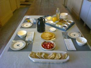a table with breakfast food on a table at La bergerie in Chaillevette