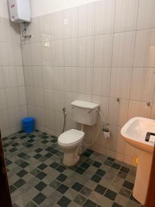 a bathroom with a toilet and a sink at May 7 in Soroti