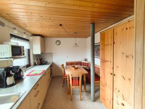 a kitchen with a small table in a room at Gästehaus Heuchert in Meersburg