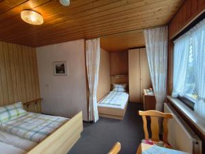 a bedroom with two beds and a window at Gästehaus Heuchert in Meersburg