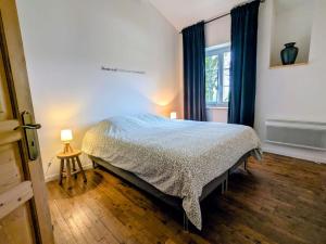 a bedroom with a bed and a window at Les Côtes - Charming holiday home with heated swimming pool in Palluaud +32 photos