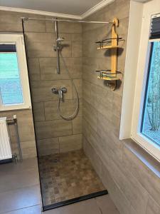 a bathroom with a shower with a glass door at Waldhaus Wangen in Burg-Reuland