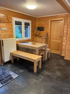 a kitchen with a table and a bench in a room at Waldhaus Wangen in Burg-Reuland +27 photos