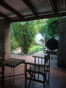 a table and a chair on a patio at Hospedaje JosEva in Unquillo