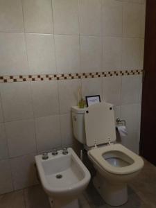 a bathroom with a toilet and a bidet at Hospedaje JosEva in Unquillo
